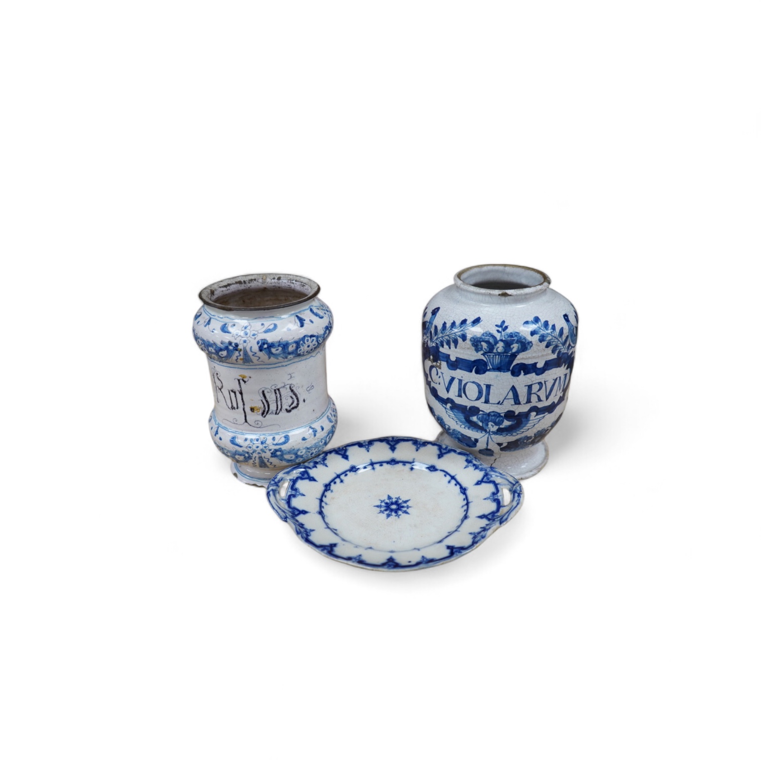 A 17th /18th century blue and white Delft apothecary jar, together with an Italian blue and white pottery drug jar and a blue and white ‘Saxon Star’ two handled dish, tallest 19cm. Condition - poor